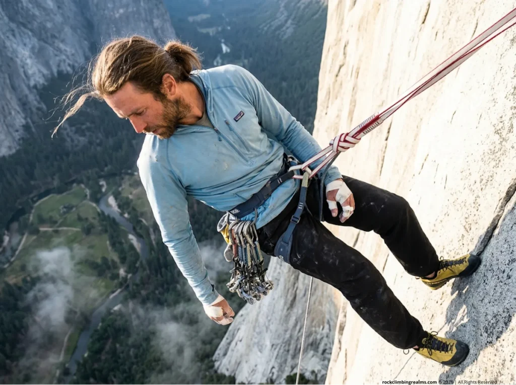 Big wall climber resting on a tether, showing harness tie in points explained loop vs belay hazards.