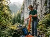 4 Ways Climbers Spread Invasive Species Unknowingly Climber sorting gear at a green crag, an area where climbers spread invasive species unknowingly.