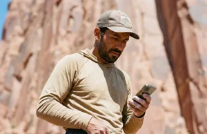 4 Mistakes That Ruin Indigenous Land Climbing Access Climber using smartphone app to check indigenous land climbing access respect guide boundaries