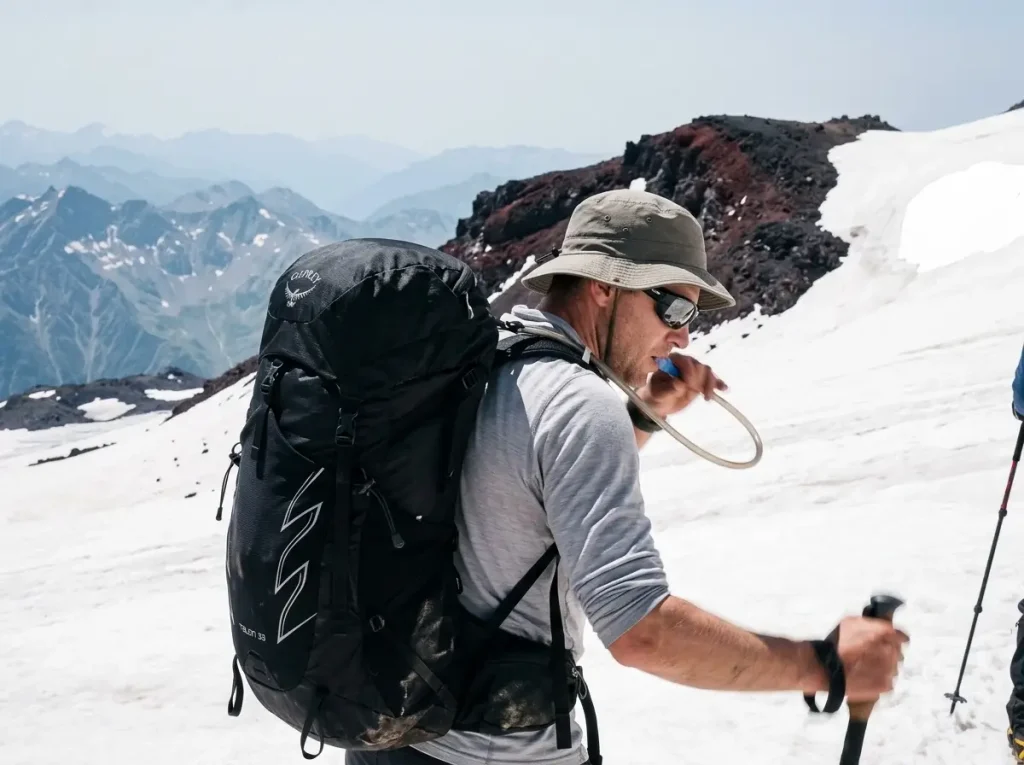 Climbers on an acclimatization hike toward Pastukhov Rocks on Elbrus practicing climb high sleep low