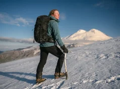 Is Mount Elbrus the Easiest Seven Summit? Sort Of Climber on Mount Elbrus snow slope with the twin volcanic summits behind, easiest Seven Summit