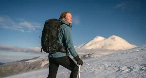 Is Mount Elbrus the Easiest Seven Summit? Sort Of Climber on Mount Elbrus snow slope with the twin volcanic summits behind, easiest Seven Summit