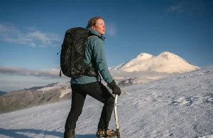 Is Mount Elbrus the Easiest Seven Summit? Sort Of Climber on Mount Elbrus snow slope with the twin volcanic summits behind, easiest Seven Summit