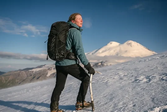 Is Mount Elbrus the Easiest Seven Summit? Sort Of Climber on Mount Elbrus snow slope with the twin volcanic summits behind, easiest Seven Summit