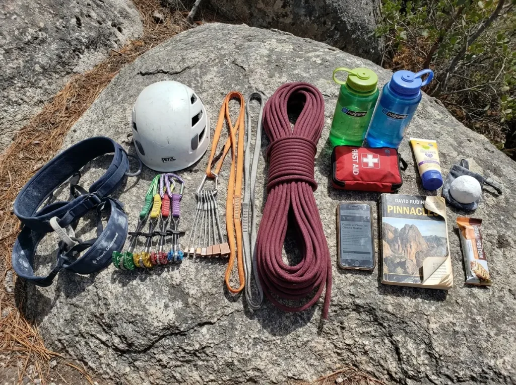Climber gear layout for Pinnacles National Park including trad rack helmet and water