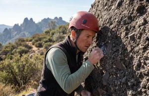 5 Pinnacles Climbing Mistakes That Get You Hurt Climber inspecting volcanic breccia rock face at Pinnacles National Park with helmet on
