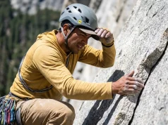 The 5-Step Rockfall Hazard Assessment For Climbers Climber doing a rockfall hazard assessment at a granite wall