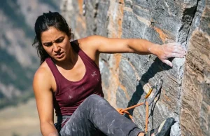 The Rumney New Hampshire Climbing Guide I Wish I Had Female climber leading a route for the Rumney New Hampshire climbing guide using a taut rope and precise footwork.