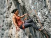 How to Practice Falling in Sport Climbing the Right Way Climber practicing a controlled lead fall on overhanging limestone sport route with Petzl harness