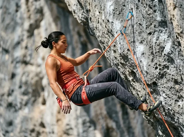 sport-climbing-fall-practice-lead-falling Climber practicing a controlled lead fall on overhanging limestone sport route with Petzl harness