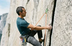 Trad Climbing Grade Conversion Chart Pros Use Trad climber laybacking a granite crack with Black Diamond Camalot placed above on a sunlit cliff face