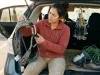 How to Buy Used Climbing Gear Without Getting Burned Climber inspecting used climbing cam with detailed focus before buying used gear