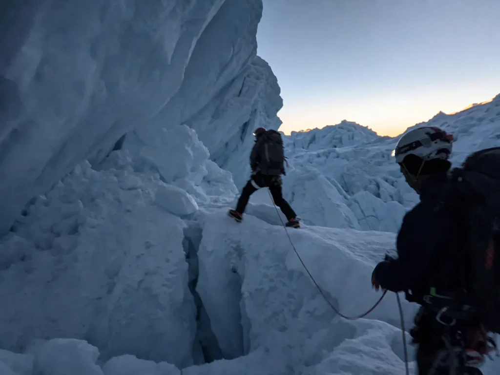 Rope team crossing the crevassed icefall below La Garganta before dawn on Huascaran — why climbers turn back