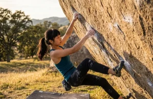 Why Ashima Shiraishi Sent V15 Before Most Adults Young female climber sending a powerful boulder move on granite at golden hour