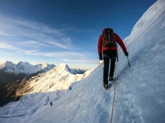 Why Most Huascaran Climbers Fail at La Garganta Climber ascending steep glacier on Huascaran with Cordillera Blanca peaks in background
