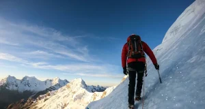 Why Most Huascaran Climbers Fail at La Garganta Climber ascending steep glacier on Huascaran with Cordillera Blanca peaks in background