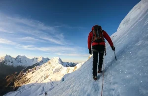 Why Most Huascaran Climbers Fail at La Garganta Climber ascending steep glacier on Huascaran with Cordillera Blanca peaks in background