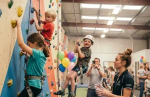 5 Climbing Gym Party Mistakes Parents Keep Making Kids climbing colorful gym wall during a birthday party celebration