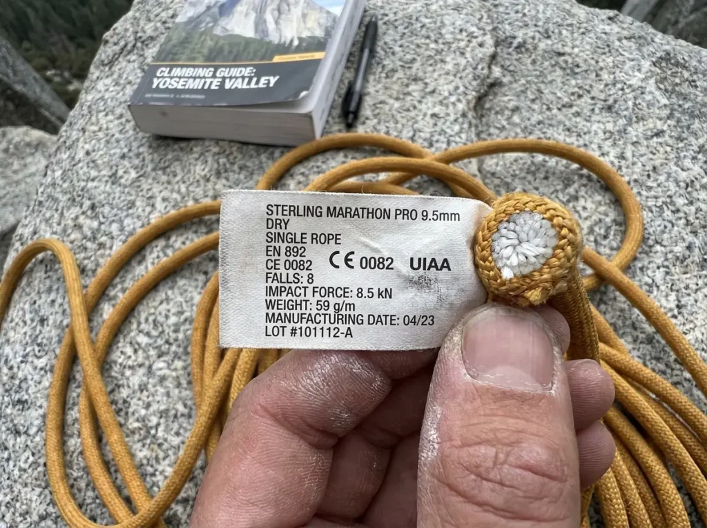 Close-up of climbing rope label showing UIAA fall rating and specifications
