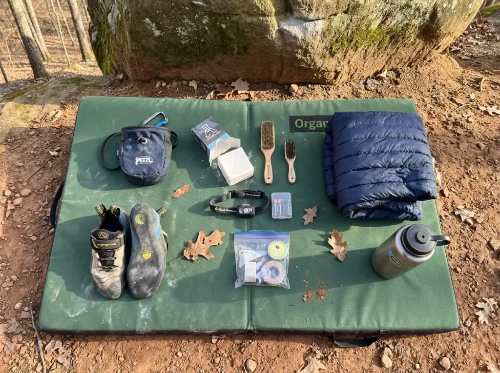 Bouldering gear laid out on crash pad before Horse Pens 40 session
