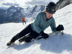 Why Most Climbers Fail at Ice Axe Self-Arrest Mountaineer practicing ice axe self-arrest on steep snow slope
