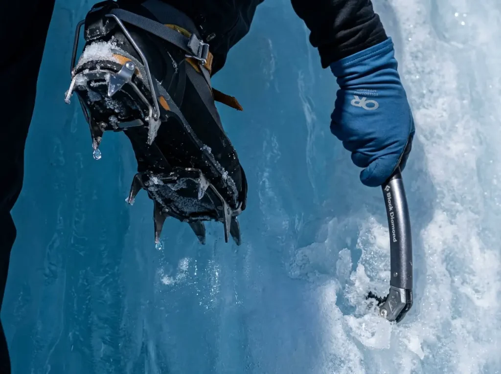 Close-up of crampon front-points and ice tool picks showing sharp gear hazards