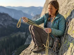 When to Retire Soft Goods and What to Check Climber inspecting worn nylon slings at a granite belay station