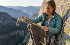 When to Retire Soft Goods and What to Check Climber inspecting worn nylon slings at a granite belay station