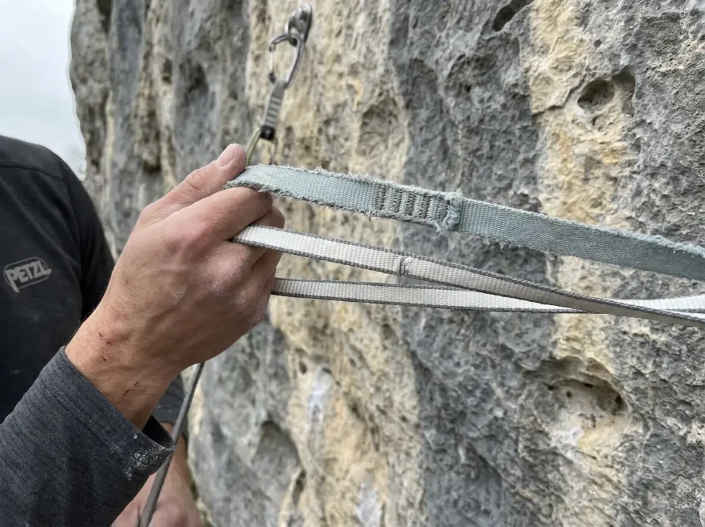 Side by side comparison of aged nylon and Dyneema climbing slings showing wear
