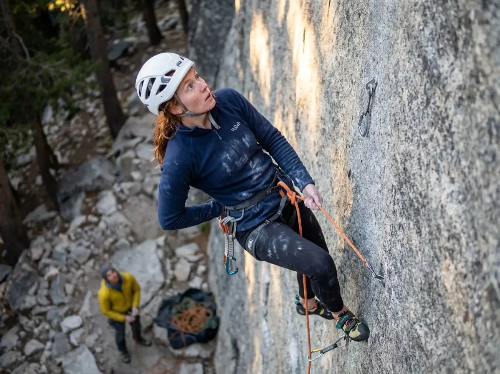 Climber pausing mid-route outdoors managing fear and exposure anxiety