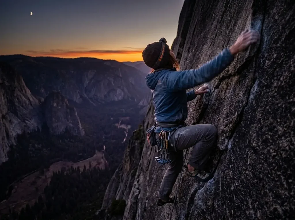 Climber moving fast on El Capitan granite at last light, evoking the sub-24-hour one-day free ascent of The Nose