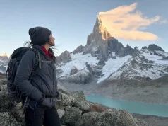 Cerro Torre Climbing History and Routes Cerro Torre granite spire capped in rime ice at dawn, a lone climber looking up from the approach