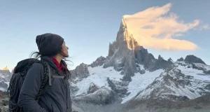 Cerro Torre Climbing History and Routes Cerro Torre granite spire capped in rime ice at dawn, a lone climber looking up from the approach