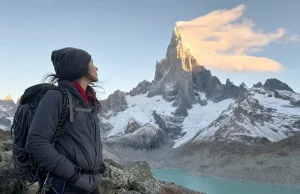 Cerro Torre Climbing History and Routes Cerro Torre granite spire capped in rime ice at dawn, a lone climber looking up from the approach