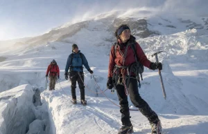 4 Mount Rainier Routes and Who Each One Is For Roped climbing team crossing a glacier on Mount Rainier at first light