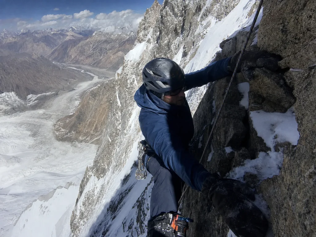 Climber on the steep technical rock of K2's Cesen route spur