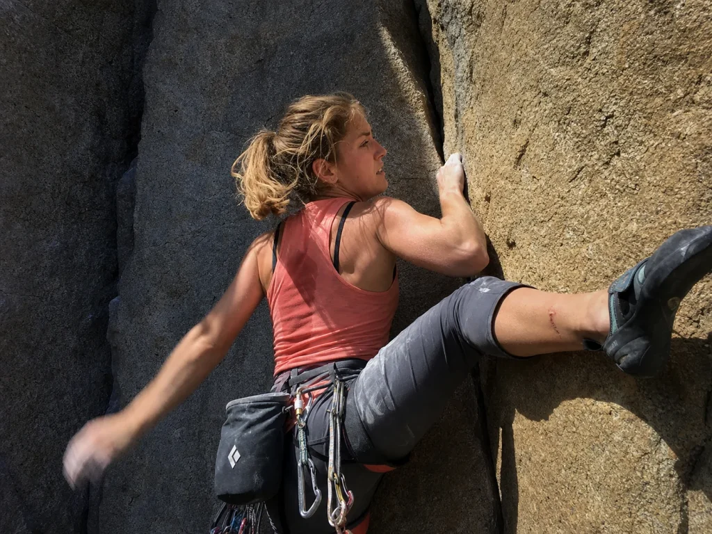 Free climber laybacking a granite corner on El Capitan with chalked hands and no aid gear