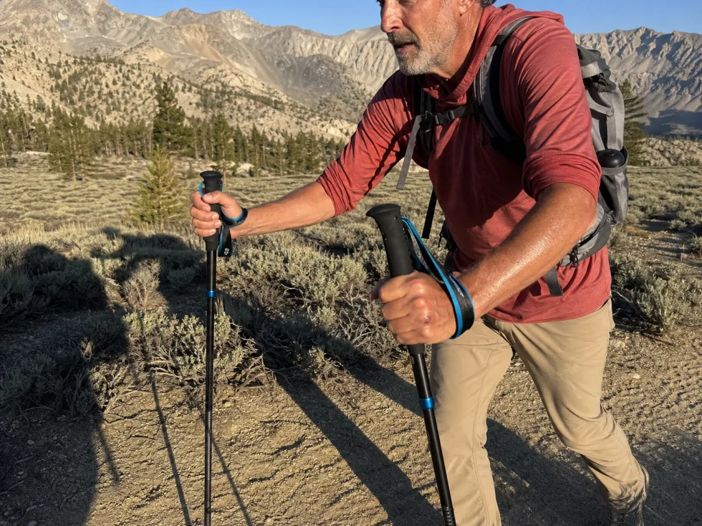 Hiker using Black Diamond Distance Z trekking poles on a high-altitude acclimatization hike