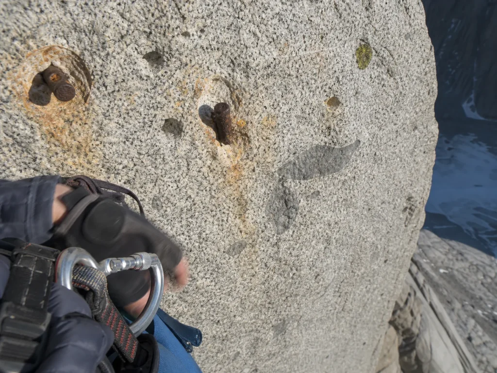 Bolt scars and empty hanger holes on Cerro Torre's granite headwall after the 2012 de-bolting