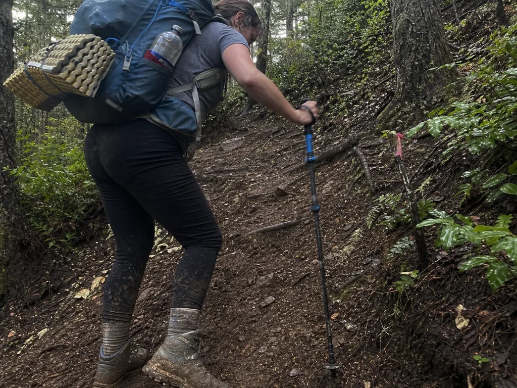 Climber training with a weighted pack on a steep local trail before Mount Rainier
