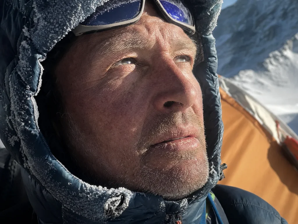 Weathered close-up of a veteran high-altitude climber at a K2 high camp