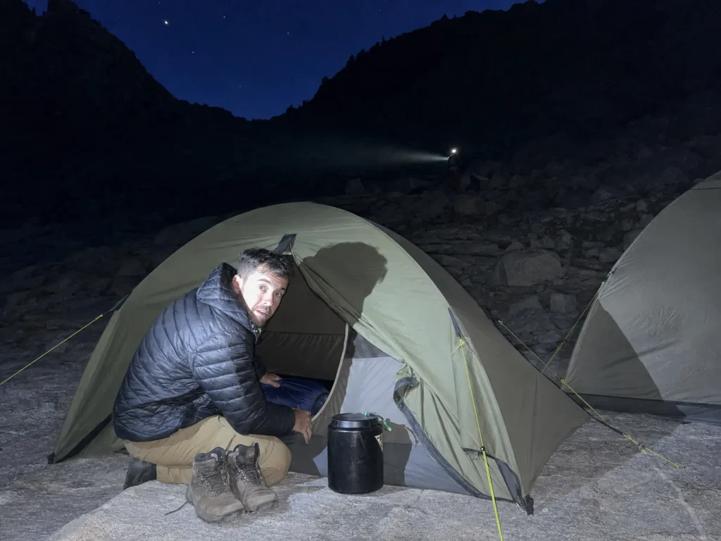 Tents at Trail Camp below the Mount Whitney switchbacks at dusk with headlamps coming on