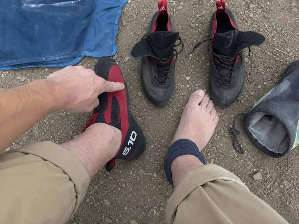 Slip-on climbing shoe beside a laced pair showing closure options for a high instep